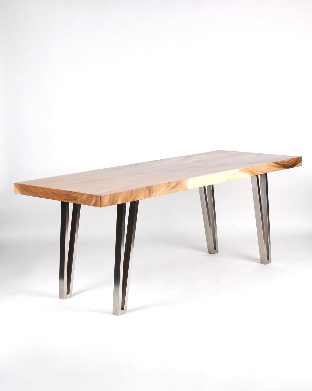 A rectangular dining table with a wooden top and stainless steel legs, positioned on a white background. The table appears to have a modern design with a significant discrepancy in material and style.