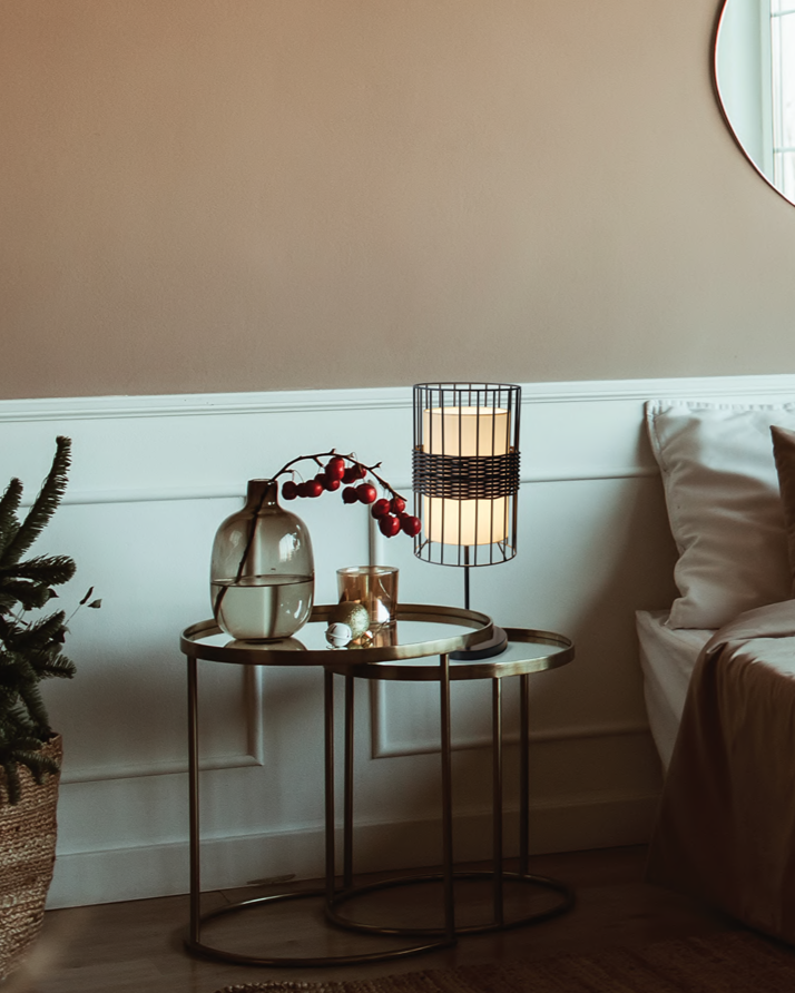 Decorative setup with a small table, lamp, and plant in a room.